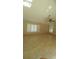 Spacious bedroom with ceiling fan, tiled floors, and plantation shutters at 8626 N 50Th Ln, Glendale, AZ 85302