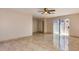 Bedroom featuring tile floors, base trim, and a large window for natural light at 8626 N 50Th Ln, Glendale, AZ 85302