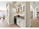 Stylish bar area featuring white cabinetry and built-in wine cooler at 8657 E Aster Dr, Scottsdale, AZ 85260