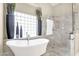 Well-appointed bathroom featuring a soaking tub, a glass enclosed shower, and elegant tile work at 8657 E Aster Dr, Scottsdale, AZ 85260