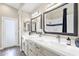 Bright bathroom featuring double vanity, stylish fixtures, and large mirrors at 8657 E Aster Dr, Scottsdale, AZ 85260