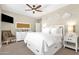 Cozy bedroom with white furniture, storage bed and ceiling fan at 8657 E Aster Dr, Scottsdale, AZ 85260