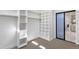 White walk-in closet with wood shelves and ample space at 8657 E Aster Dr, Scottsdale, AZ 85260