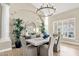 Spacious dining room with a large chandelier and natural lighting at 8657 E Aster Dr, Scottsdale, AZ 85260