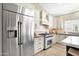 Modern kitchen featuring stainless steel appliances, custom cabinets, and a gas range with decorative backsplash at 8657 E Aster Dr, Scottsdale, AZ 85260