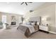 Large main bedroom features a neutral color palette, fireplace, ceiling fan, and ample natural light at 8657 E Aster Dr, Scottsdale, AZ 85260