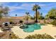 Sparkling pool with a rock waterfall feature is surrounded by lush landscaping and a private backyard oasis at 8657 E Aster Dr, Scottsdale, AZ 85260