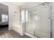 Modern bathroom featuring a bathtub and glass-enclosed shower and wood-look flooring at 9360 E Milagro Ave, Mesa, AZ 85209