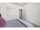 Bedroom with a view of closet and door, it features neutral walls and carpet flooring at 9360 E Milagro Ave, Mesa, AZ 85209