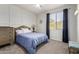 Stylish bedroom featuring a comfortable bed, neutral walls, and a bright window with elegant curtains at 9360 E Milagro Ave, Mesa, AZ 85209