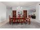 Elegant dining room featuring a large table, seating for eight, and a chandelier for warm lighting at 9360 E Milagro Ave, Mesa, AZ 85209