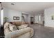 Comfortable living room with a large sectional sofa, neutral tones, and tiled entry at 9360 E Milagro Ave, Mesa, AZ 85209