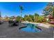 Beautiful pool with a lounging area perfect for entertaining in a landscaped backyard at 9360 E Milagro Ave, Mesa, AZ 85209