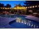 Pool area with charming string lights reflecting on the water, perfect for evening relaxation at 9360 E Milagro Ave, Mesa, AZ 85209