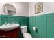 Stylish powder room featuring decorative molding, a sink vanity, and modern toilet at 9360 E Milagro Ave, Mesa, AZ 85209