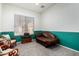 Cozy sitting room with a comfortable leather sofa and a large window with natural light at 9360 E Milagro Ave, Mesa, AZ 85209