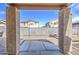 View of the backyard with a concrete patio and gravel landscaping framed by stucco columns under a covered area at 9404 W Pierson St, Phoenix, AZ 85037