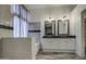 Modern bathroom with a soaking tub, dual vanities, and tiled walls at 9404 W Pierson St, Phoenix, AZ 85037