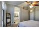 Bedroom with a view of the bathroom, neutral walls, and large mirror at 9404 W Pierson St, Phoenix, AZ 85037