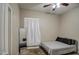 Neutral bedroom featuring a cozy queen bed, ceiling fan, and a large mirror at 9404 W Pierson St, Phoenix, AZ 85037