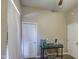 Bedroom featuring neutral walls and trim, carpet flooring, a cage and two entry doors at 9404 W Pierson St, Phoenix, AZ 85037