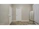 Bedroom featuring neutral walls, carpet flooring, a full length mirror, and white doors at 9404 W Pierson St, Phoenix, AZ 85037