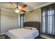 Inviting bedroom with a tufted headboard, neutral walls, and a ceiling fan at 9404 W Pierson St, Phoenix, AZ 85037