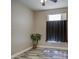 Bedroom featuring neutral walls, plank flooring, a potted plant, and a window at 9404 W Pierson St, Phoenix, AZ 85037