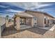 A covered patio in the backyard with gravel landscaping and black iron fence at 9404 W Pierson St, Phoenix, AZ 85037