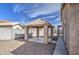 A covered back patio with gray gravel landscaping and black iron fence at 9404 W Pierson St, Phoenix, AZ 85037