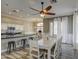 Bright dining area with a white table, chairs, open to kitchen and features elegant pendant lighting at 9404 W Pierson St, Phoenix, AZ 85037