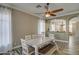 Inviting dining area with a white table, bench seating, neutral walls, and wood-look flooring, perfect for entertaining at 9404 W Pierson St, Phoenix, AZ 85037