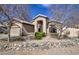 Charming home featuring mature trees, rock landscaping, and a welcoming two-car garage at 9404 W Pierson St, Phoenix, AZ 85037