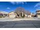 Inviting home with a two-car garage, mature landscaping, and a charming facade at 9404 W Pierson St, Phoenix, AZ 85037