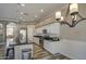 Bright kitchen featuring a large island, white cabinetry, stainless steel appliances, and stylish pendant lighting at 9404 W Pierson St, Phoenix, AZ 85037