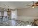 Spacious living room featuring wood-look flooring, chandelier, and a bar counter at 9404 W Pierson St, Phoenix, AZ 85037