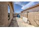 Long side yard with a concrete pad, stucco walls, and exterior storage at 9404 W Pierson St, Phoenix, AZ 85037