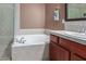 Elegant bathroom showcasing a soaking tub with tiled surround and vanity at 9715 N Azure Ct # 4, Fountain Hills, AZ 85268