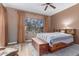 Cozy bedroom with wood-look floors, a decorative wood bed frame, and natural light from a large window at 9715 N Azure Ct # 4, Fountain Hills, AZ 85268