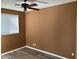 Bedroom with neutral paint and laminate floor, featuring a window with blinds and ceiling fan at 9715 N Azure Ct # 4, Fountain Hills, AZ 85268