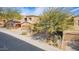 Tan two-story home featuring a two-car garage, desert landscaping, and mature trees at 9715 N Azure Ct # 4, Fountain Hills, AZ 85268