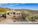 Tan two-story home with a tile roof in a community with desert landscaping and mountain views at 9715 N Azure Ct # 4, Fountain Hills, AZ 85268