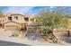 Tan two-story home featuring a two-car garage, desert landscaping, and mature trees at 9715 N Azure Ct # 4, Fountain Hills, AZ 85268