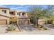 Tan two-story home featuring a two-car garage and desert landscaping with mature trees at 9715 N Azure Ct # 4, Fountain Hills, AZ 85268