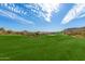 Expansive view of a green golf course with clear blue sky and desert mountain scenery in the background at 9715 N Azure Ct # 4, Fountain Hills, AZ 85268