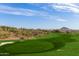 Picturesque view of a lush golf course, desert landscape, and distant mountain peak under a sunny sky at 9715 N Azure Ct # 4, Fountain Hills, AZ 85268