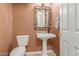 Charming half-bathroom with pedestal sink, decorative mirror, and neutral colors at 9715 N Azure Ct # 4, Fountain Hills, AZ 85268