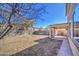 Expansive backyard featuring a covered patio, block wall fencing, and low maintenance landscaping under a clear sky at 1016 E Saddleback Pl, San Tan Valley, AZ 85143