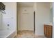 Bathroom features a shower, soaking tub, wood cabinets, and tile flooring at 1016 E Saddleback Pl, San Tan Valley, AZ 85143