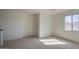 Bright bedroom features neutral carpet, white walls, two closets, and a window at 1016 E Saddleback Pl, San Tan Valley, AZ 85143